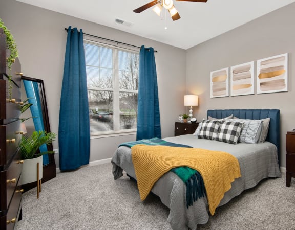 Cozy Bedroom with Plush Carpeting and Large Windows at Thornberry Woods Apartments Homes in Naperville, Illinois