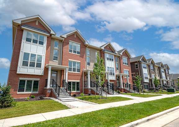a row of brick apartment buildings on a sunny day