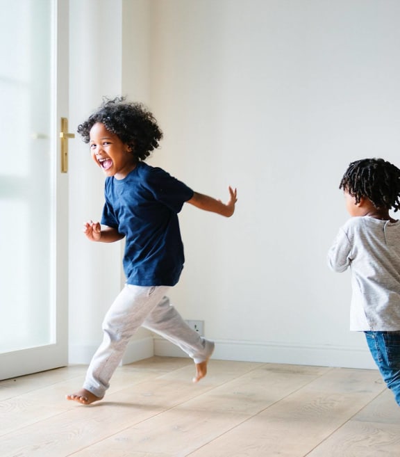 Two children playing in a house