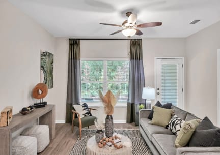 a living room with a couch and a ceiling fan at Claret Village at LaFayette Trail, Tallahassee, 32311