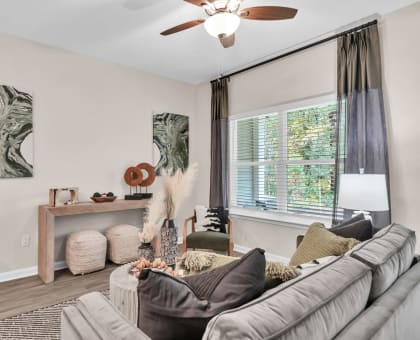 a living room with a couch and a ceiling fan at Claret Village at LaFayette Trail, Florida