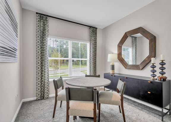 a dining room with a table and chairs and a window at Claret Village at LaFayette Trail, Tallahassee, 32311