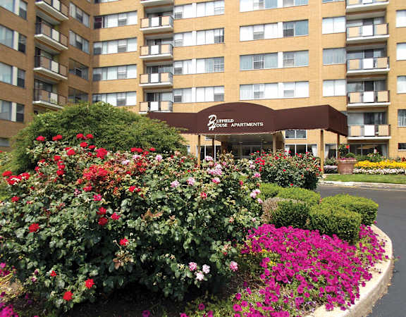 A building with a brown awning and the words "Brentfield Apartments" on it.