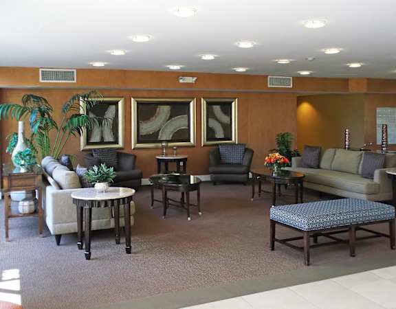 A living room with a couch, chair, and table.
