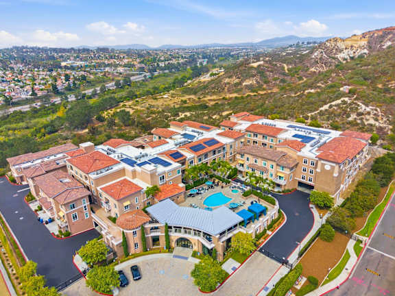 A large building with a pool in the middle of a courtyard.
