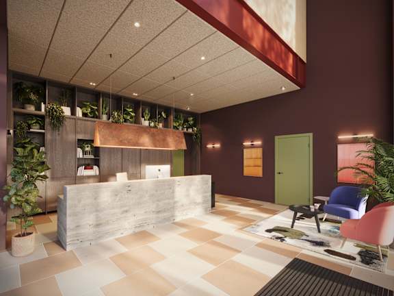A reception area with a white reception desk and a green door.