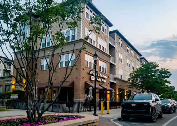 a city street with cars parked in front of a building