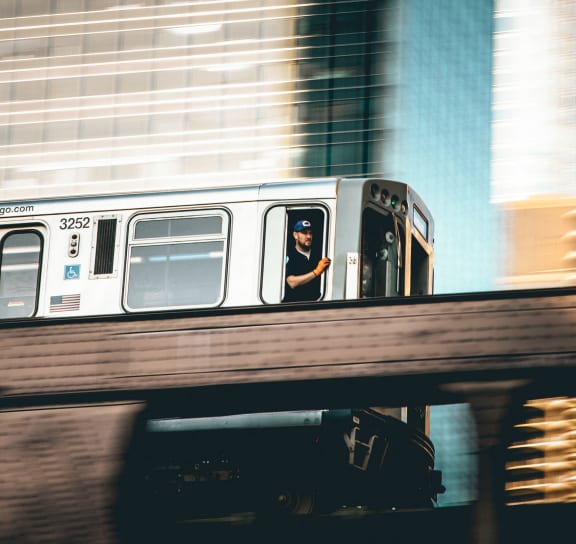 a man looking out the window of a subway train