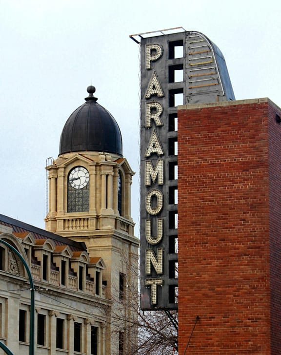 A Paramount sign is on a brick building.