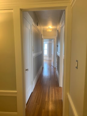 Front hallway with wainscoting and built-in cabinets.