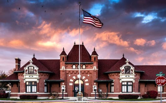 a house with an flag in front of a cloudy sky at Southside Townhomes, Nampa, 83686