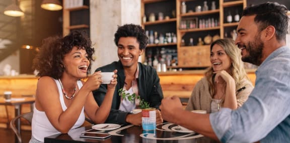 a group of people sitting at a table in a restaurant