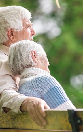 an older man and woman with their arms around each other