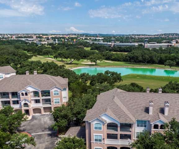 aerial view of multiple apartment buildings with a lake in the background