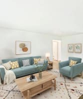 a living room with a blue couch and a coffee table at Whisperwood, Seattle
