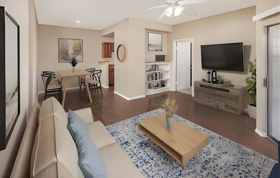 A living room with a beige couch, a wooden coffee table, and a ceiling fan.