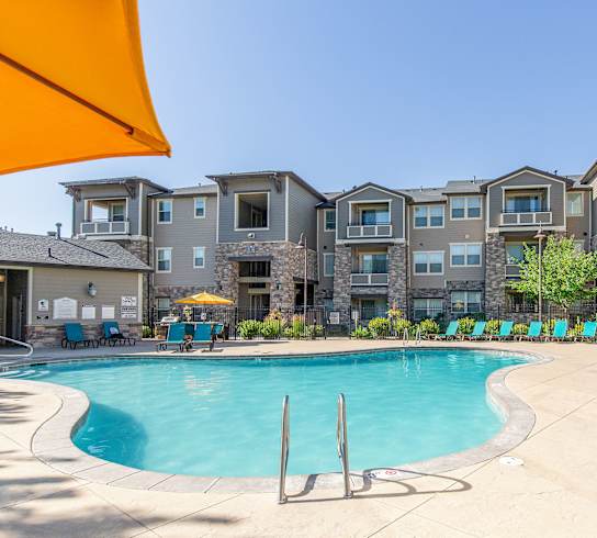 Swimming Pool With Lounge Chairs at San Tropez Apartments & Townhomes, South Jordan, Utah