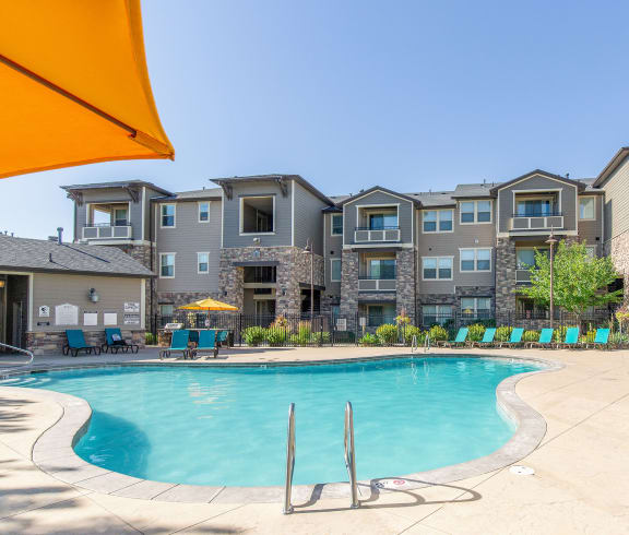 Swimming Pool With Lounge Chairs at San Tropez Apartments & Townhomes, South Jordan, Utah