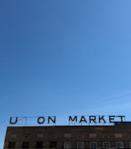 A building with a sign that says "Upon Market".