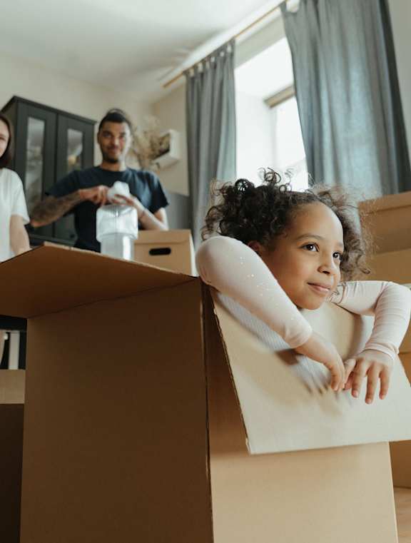 A family is unpacking boxes in their new home.