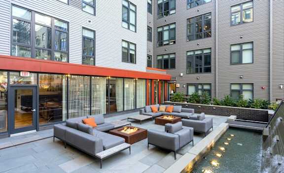 A modern outdoor seating area with a water feature.