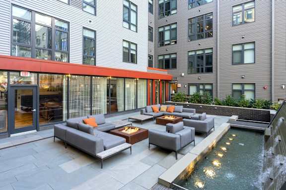 A modern outdoor seating area with a water feature.
