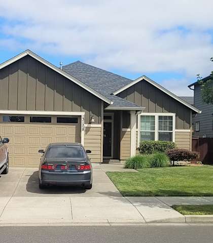 a house with two cars parked in the driveway