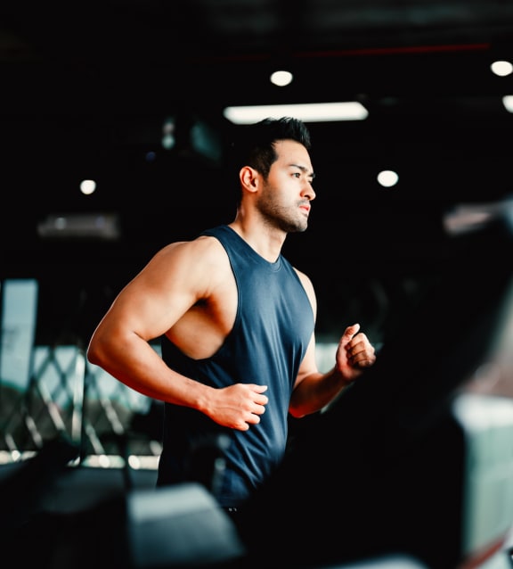 Man Running on Treadmill at Gym