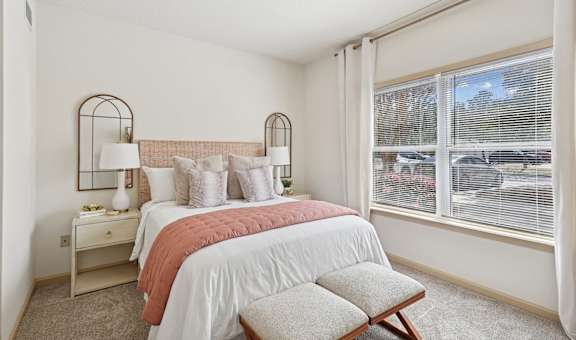 Spacious bedroom with natural light and neutral decor in Tattersall Village Apartments, Hinesville, GA