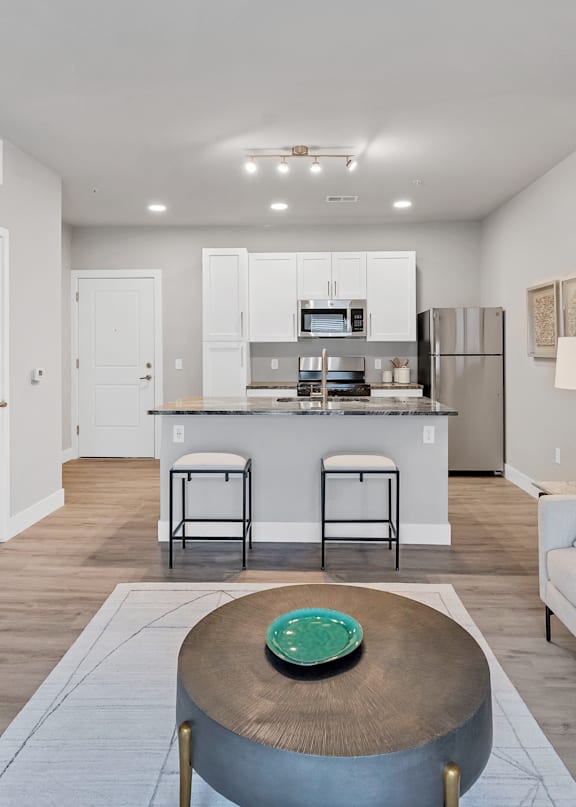 A kitchen with a bar stool and a table in front of it.