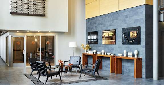a large lobby with a dining table and chairs