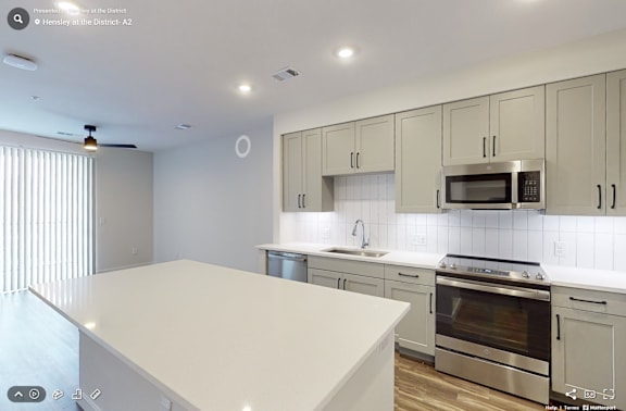 A modern kitchen with white cabinets and appliances.