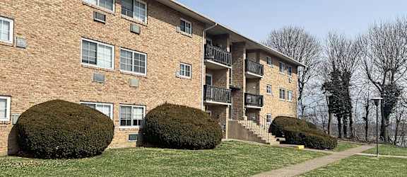 A brick building with a balcony on the second floor.