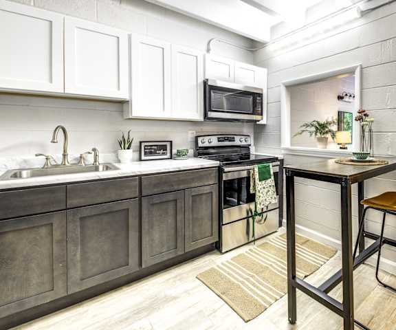 A kitchen with a table and chairs in the middle of the room.