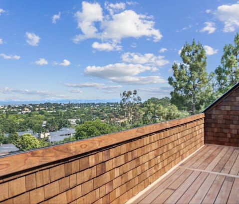 A wooden deck overlooks a cityscape.