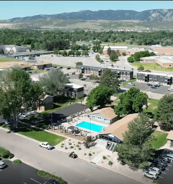 A large building complex with a pool in the middle.