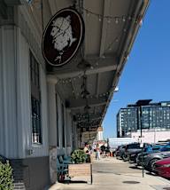 A restaurant with a large fish sign on the front.