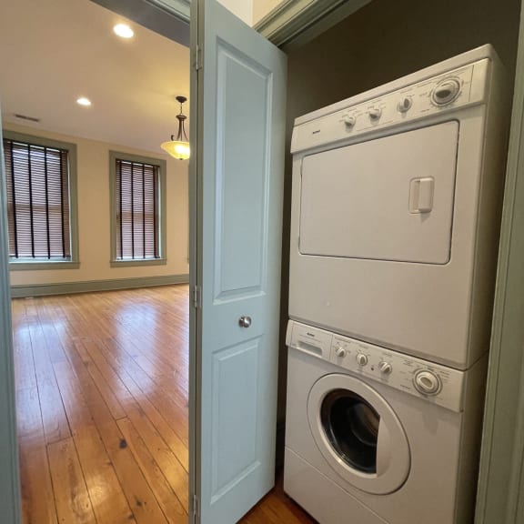 an empty laundry room with a washer and dryer in it