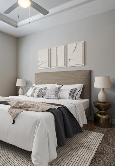 Stylish bedroom with a large window, neutral decor, and modern furnishings.