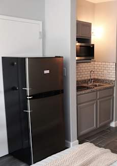 a small kitchen with a refrigerator and a sink at Schaefer Ridge Apartments, Branson