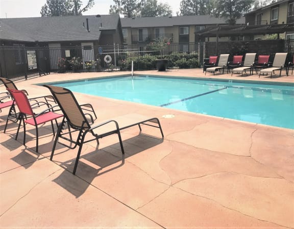 Pool and lounge chairs at Bella Park Apartments, Rialto, CA 92376