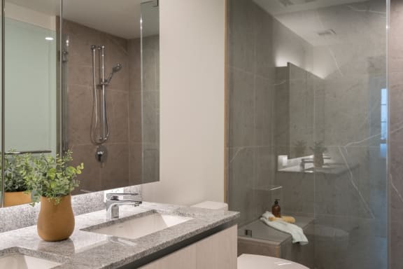 a bathroom with a sink and a shower and a toilet