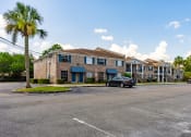 Thumbnail 16 of 18 - Exterior of Jacksonville Heights Apartments and parking lot