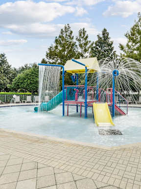 A water park with a slide and a waterfall at Wynnfield Lakes Apartments in Jacksonville, FL