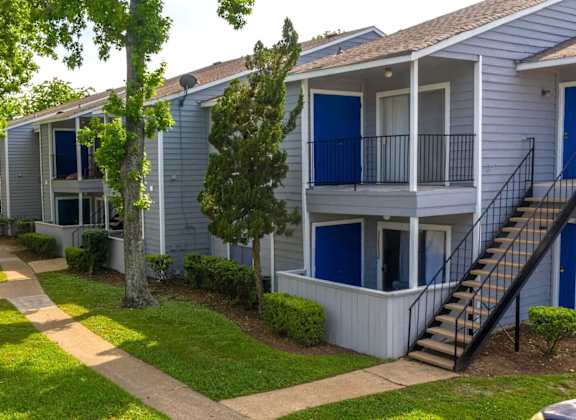 A row of houses with blue doors and windows.