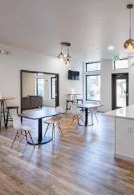 A modern kitchen with a white island and stainless steel appliances.