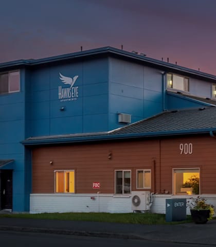 A large building with a blue and brown exterior and the number 900 on it.