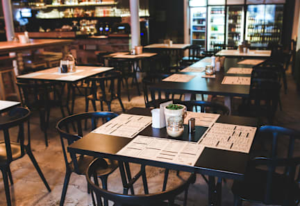 A restaurant with tables and chairs set up for dining.