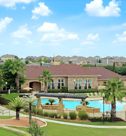 A large house with a pool in front of it.