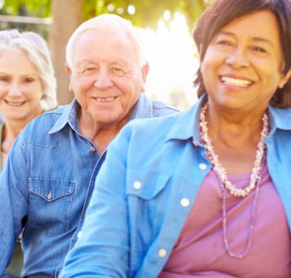 Four people sitting together outside.